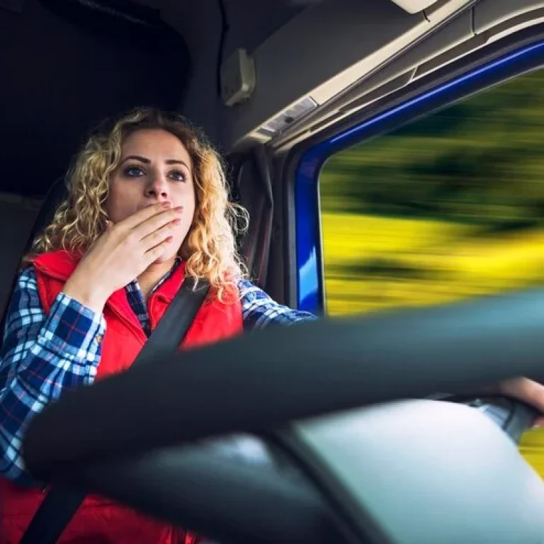female-trucker-yawning-due-tiredness-boredom-while-driving-truck_342744-277